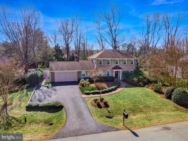 view of front facade featuring aphalt driveway, a front lawn, and an attached garage