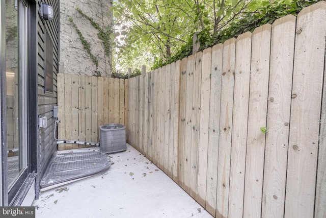 view of patio with fence and cooling unit