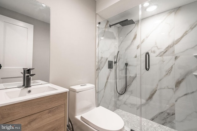 full bath with toilet, a marble finish shower, and vanity