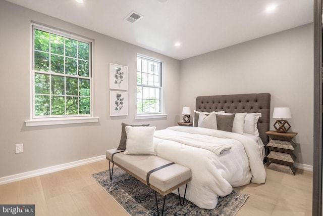 bedroom featuring recessed lighting, visible vents, light wood-style flooring, and baseboards