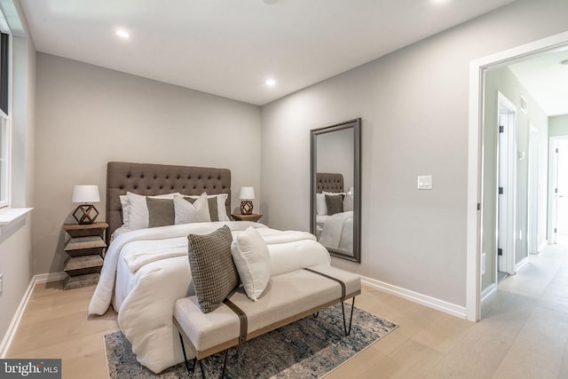 bedroom with light wood-type flooring, baseboards, and recessed lighting