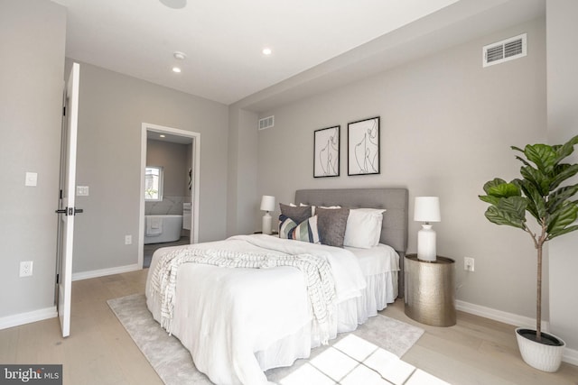 bedroom featuring light wood-style floors, baseboards, and visible vents