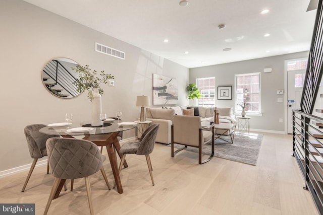 dining room featuring recessed lighting, baseboards, visible vents, and light wood finished floors