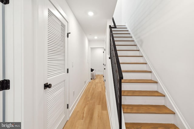 stairs featuring recessed lighting, baseboards, and wood finished floors