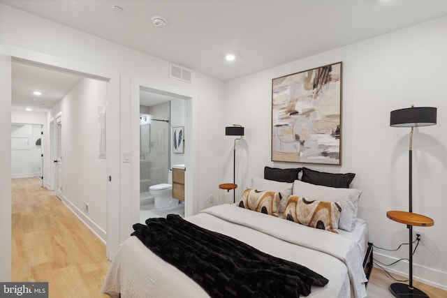 bedroom featuring recessed lighting, visible vents, ensuite bath, light wood-type flooring, and baseboards