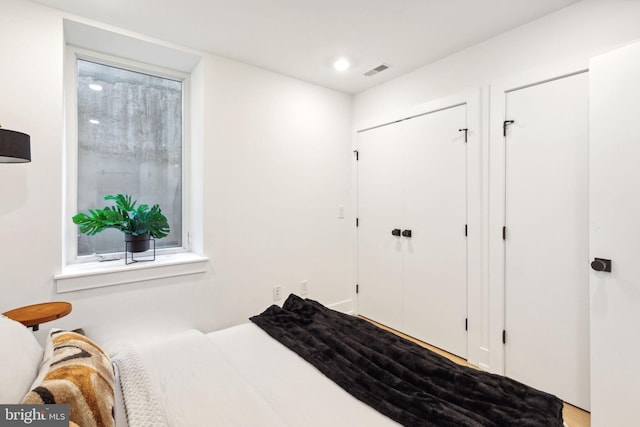 bedroom featuring visible vents