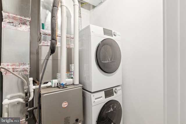 laundry room with stacked washer / dryer and laundry area