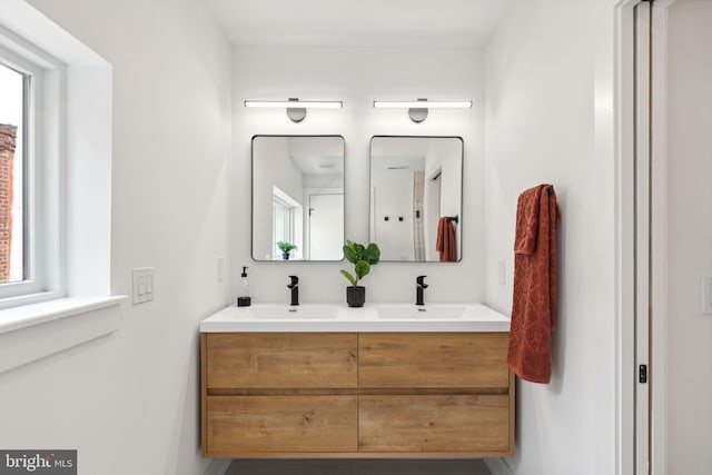 full bathroom with a sink and double vanity