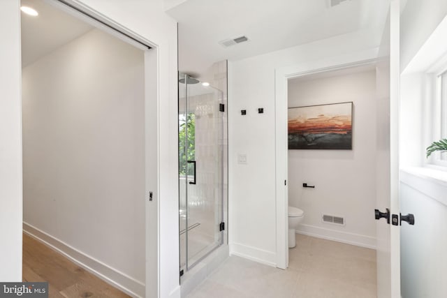 full bathroom with visible vents, baseboards, a shower stall, and toilet