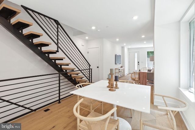 dining area featuring stairs, wood finished floors, and recessed lighting