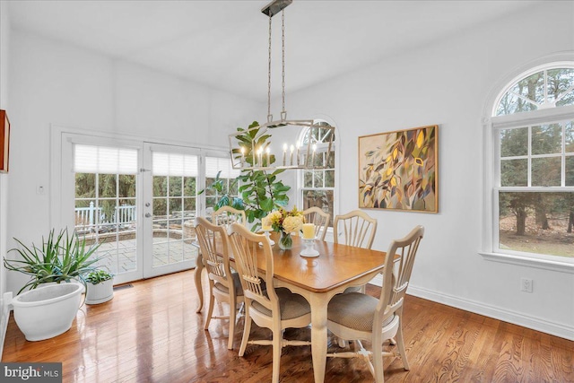 dining area with plenty of natural light, wood finished floors, and baseboards