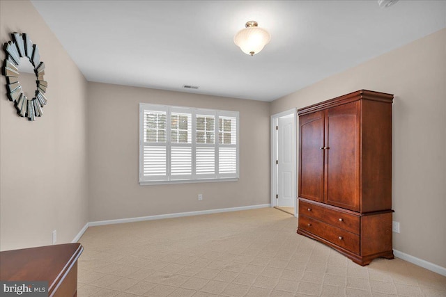 bedroom with light colored carpet, visible vents, and baseboards