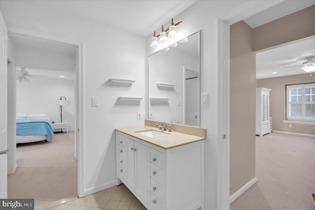 bathroom featuring a ceiling fan, connected bathroom, vanity, and baseboards