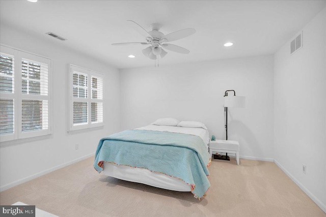 carpeted bedroom with recessed lighting, visible vents, and baseboards