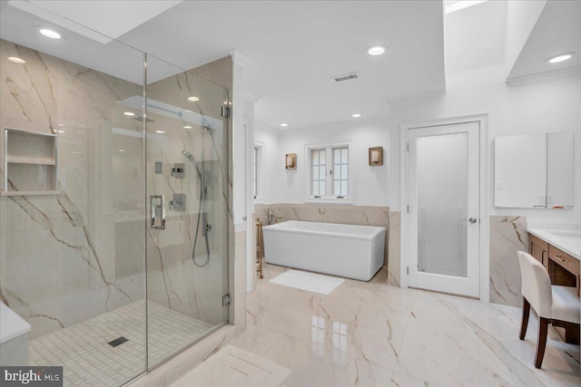 bathroom with a marble finish shower, visible vents, marble finish floor, vanity, and a freestanding tub