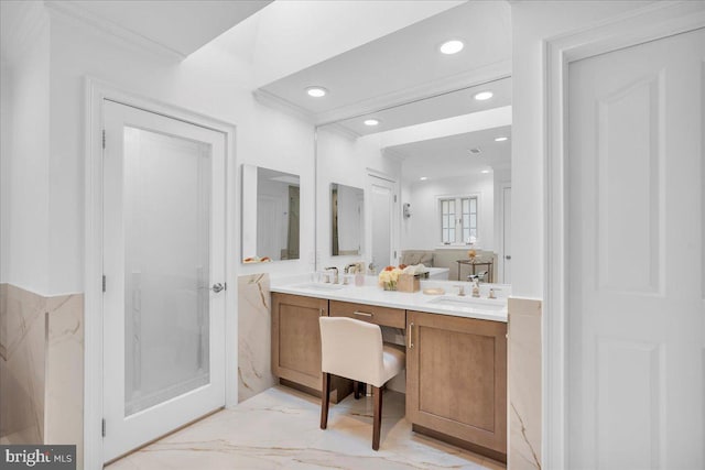 bathroom featuring ornamental molding, marble finish floor, a sink, and double vanity