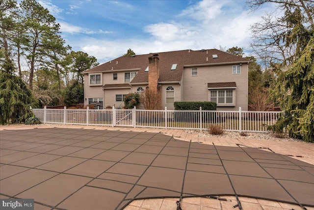 back of house featuring a fenced front yard