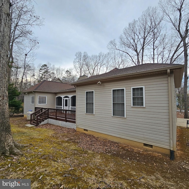 back of house with a deck and crawl space