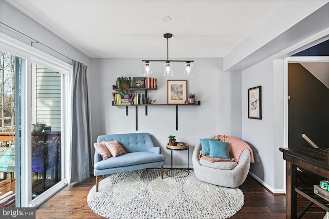 living area featuring baseboards and wood finished floors