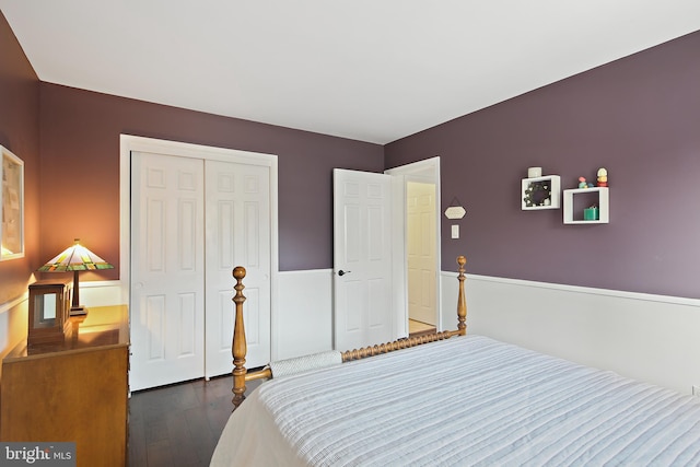 bedroom featuring a closet and dark wood-style flooring