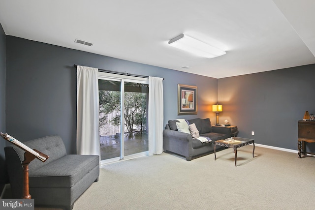 carpeted living room with baseboards and visible vents