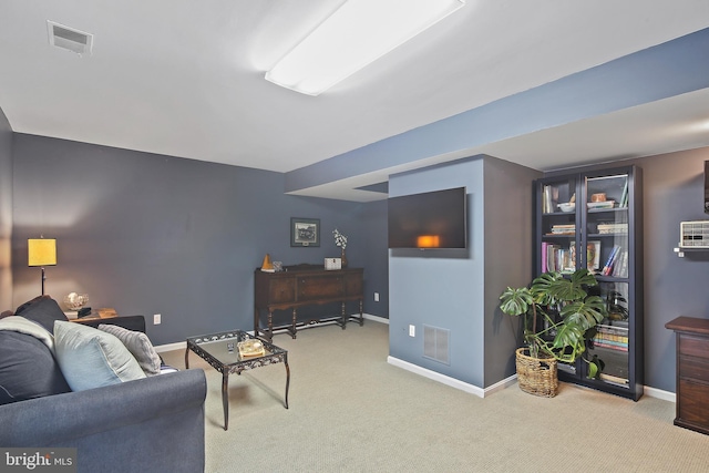 living room with visible vents, baseboards, and carpet floors