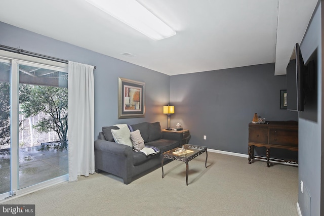 carpeted living room with visible vents and baseboards