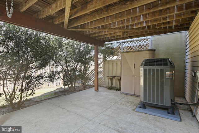 view of patio featuring central AC and fence