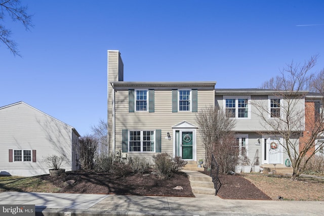 view of front of house featuring a chimney and entry steps