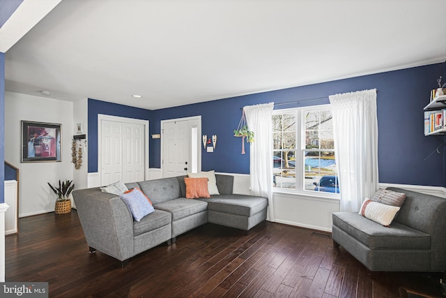 living area featuring baseboards and wood-type flooring