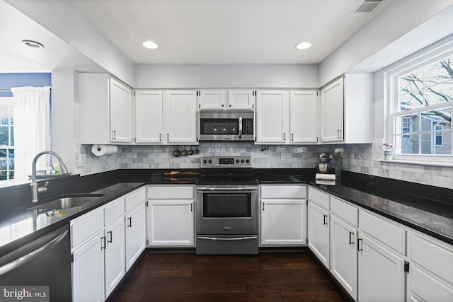 kitchen featuring white cabinets, appliances with stainless steel finishes, and a sink