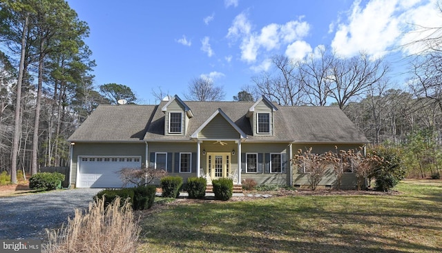 cape cod home with aphalt driveway, an attached garage, a front lawn, and crawl space