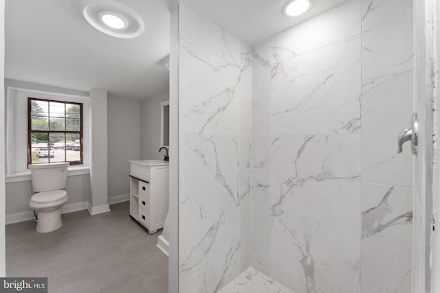 bathroom featuring baseboards, vanity, toilet, and walk in shower