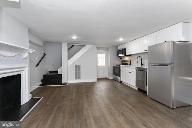 kitchen with visible vents, dark wood-style floors, appliances with stainless steel finishes, light countertops, and white cabinetry