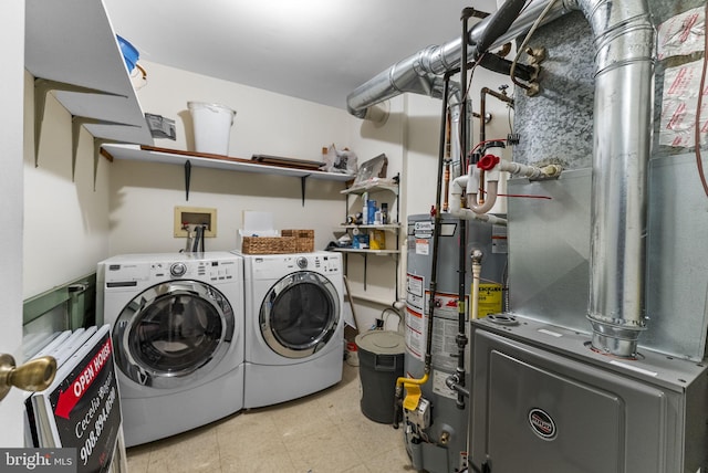 laundry area featuring gas water heater, laundry area, washer and dryer, heating unit, and light floors