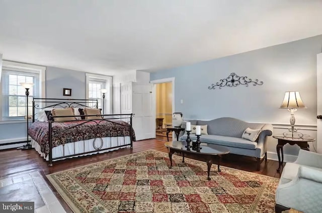 bedroom with baseboards and wood finished floors