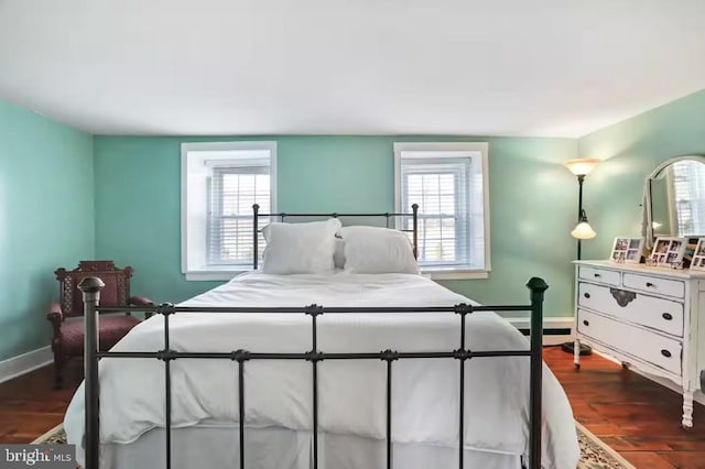 bedroom with baseboards, multiple windows, and dark wood-style floors