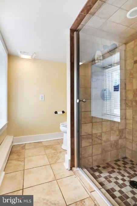 full bath featuring tile patterned floors, baseboards, toilet, and a stall shower