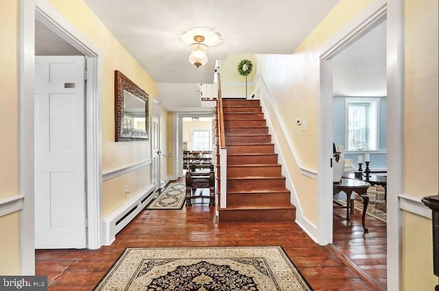 entryway featuring stairway, dark wood-style flooring, and a baseboard radiator