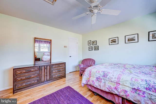 bedroom featuring light wood-type flooring, ceiling fan, and baseboards