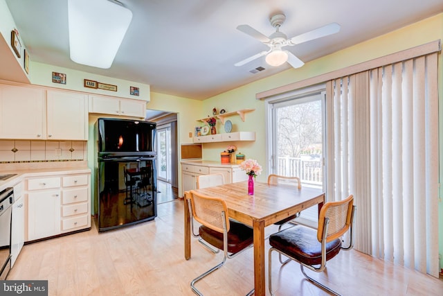 dining space with light wood-style floors and ceiling fan