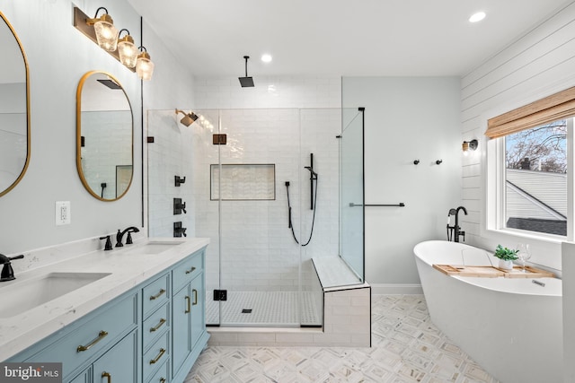 full bathroom featuring double vanity, a freestanding tub, a stall shower, and a sink