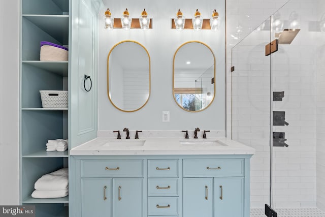 bathroom with double vanity, a stall shower, and a sink