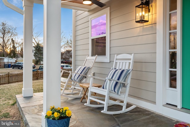 patio terrace at dusk with covered porch and fence