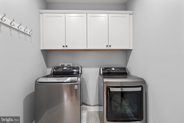 laundry room with cabinet space and separate washer and dryer