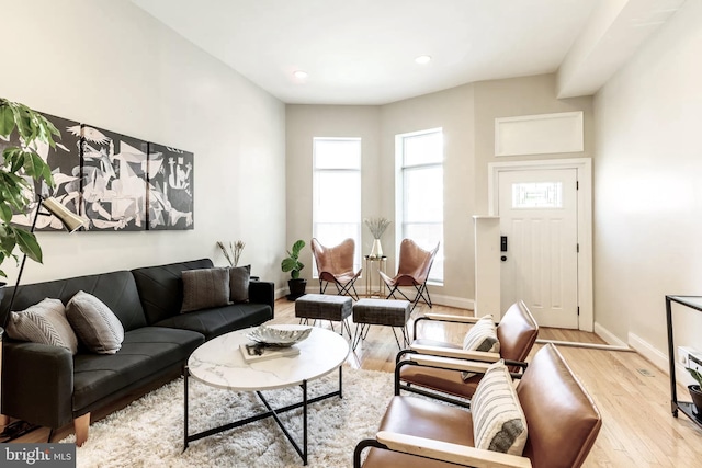 living room featuring recessed lighting, baseboards, and wood finished floors