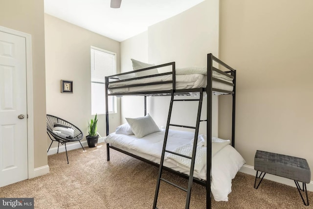 bedroom with ceiling fan, carpet floors, and baseboards