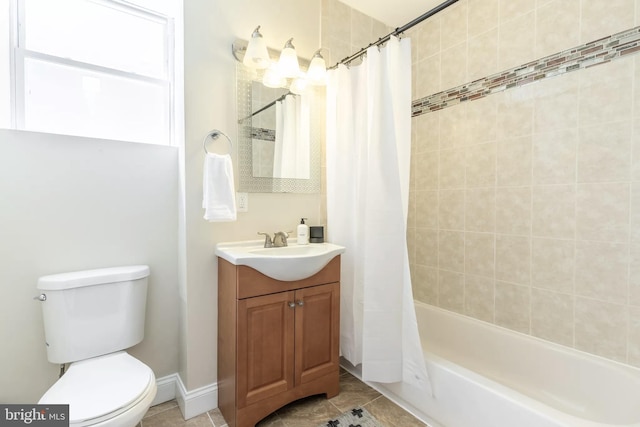 bathroom featuring toilet, tile patterned flooring, shower / bath combo with shower curtain, and vanity