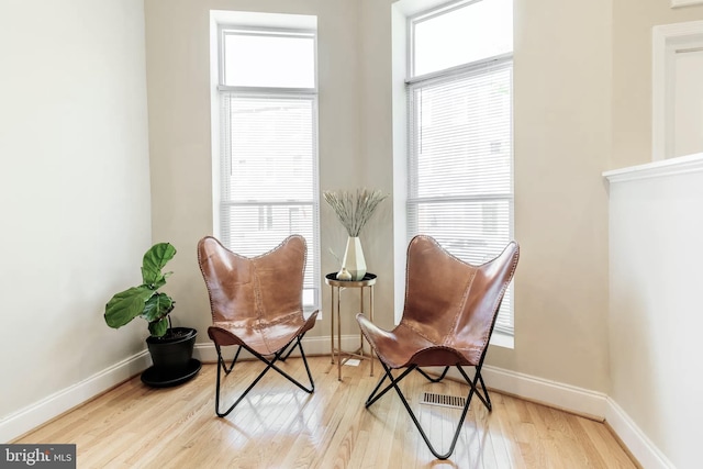 sitting room featuring light wood finished floors and baseboards