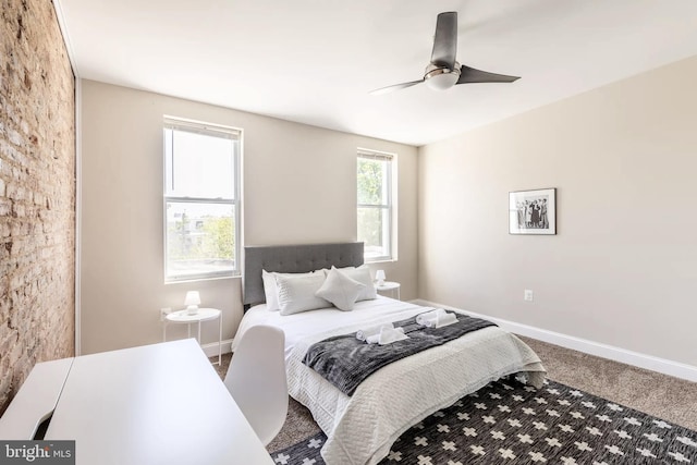 carpeted bedroom with ceiling fan and baseboards